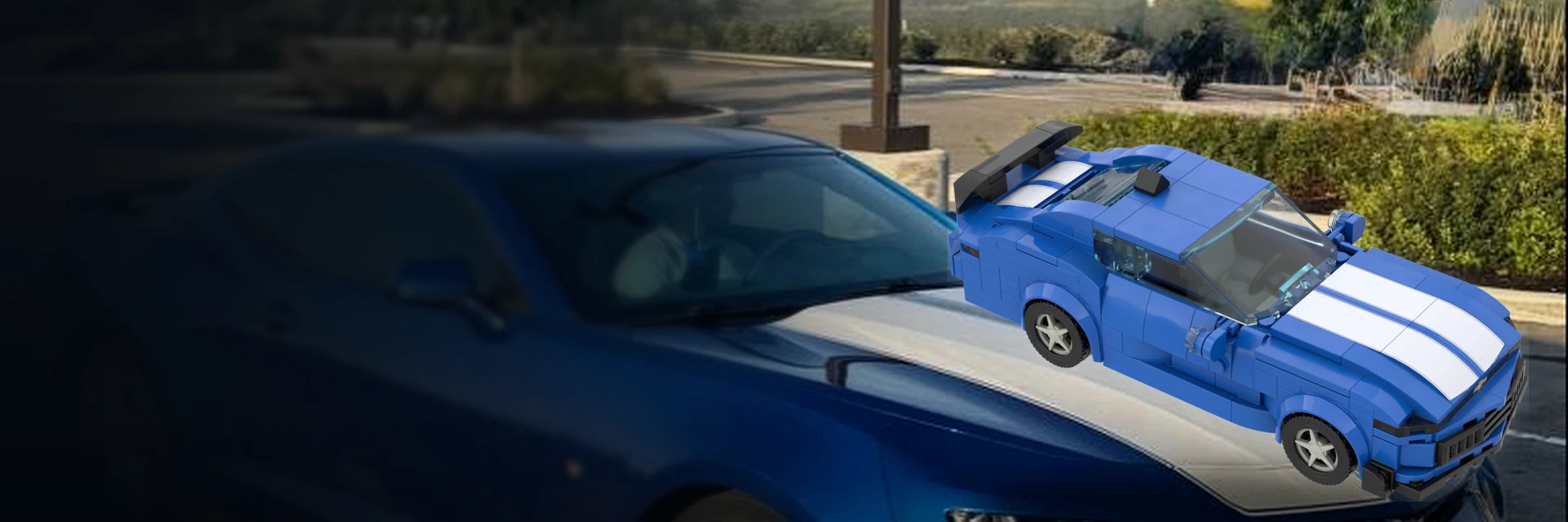 Real blue performance coupe beside its matching custom brick model