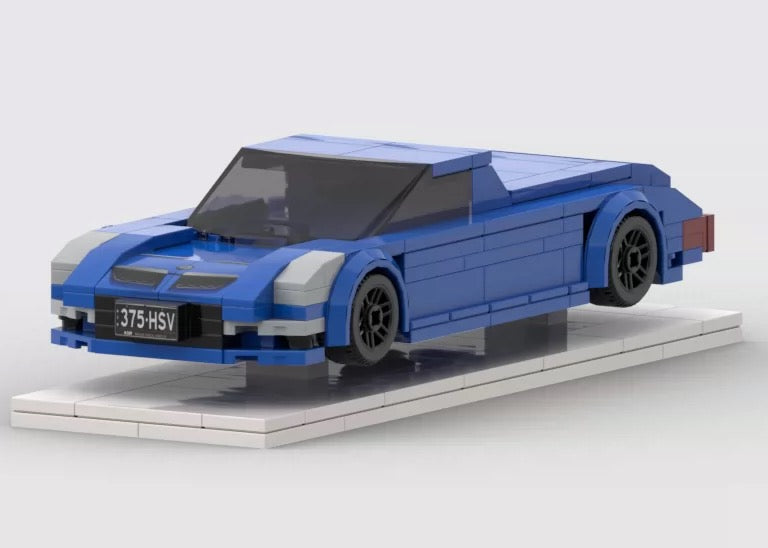 Blue brick ute design with dark wheels and a long rear deck
