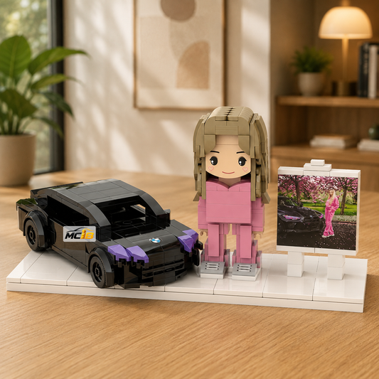 Black brick car, pink-clothed brick figure, and photo stand arranged on a white display base
