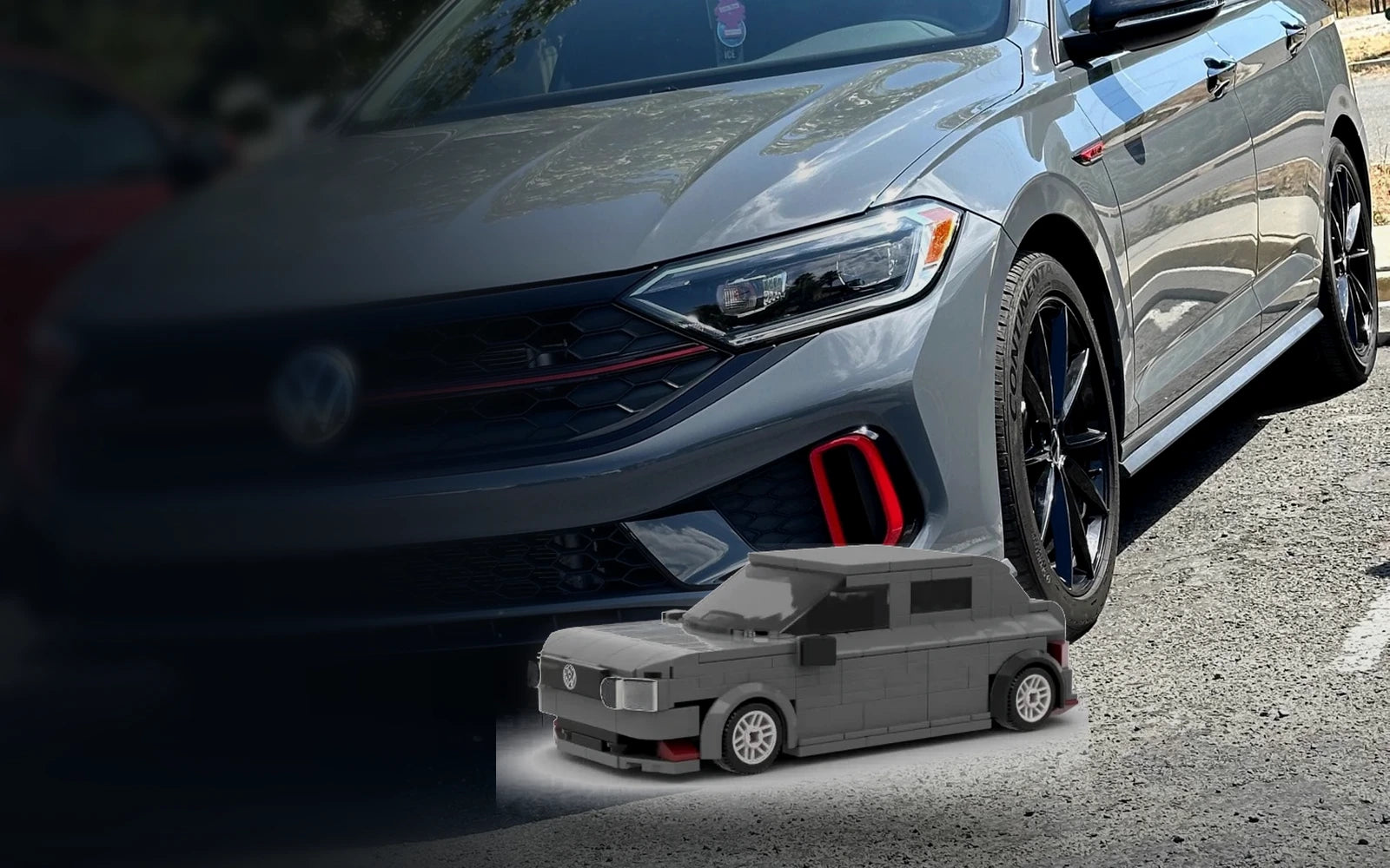 Real gray Volkswagen GLI beside its custom brick model