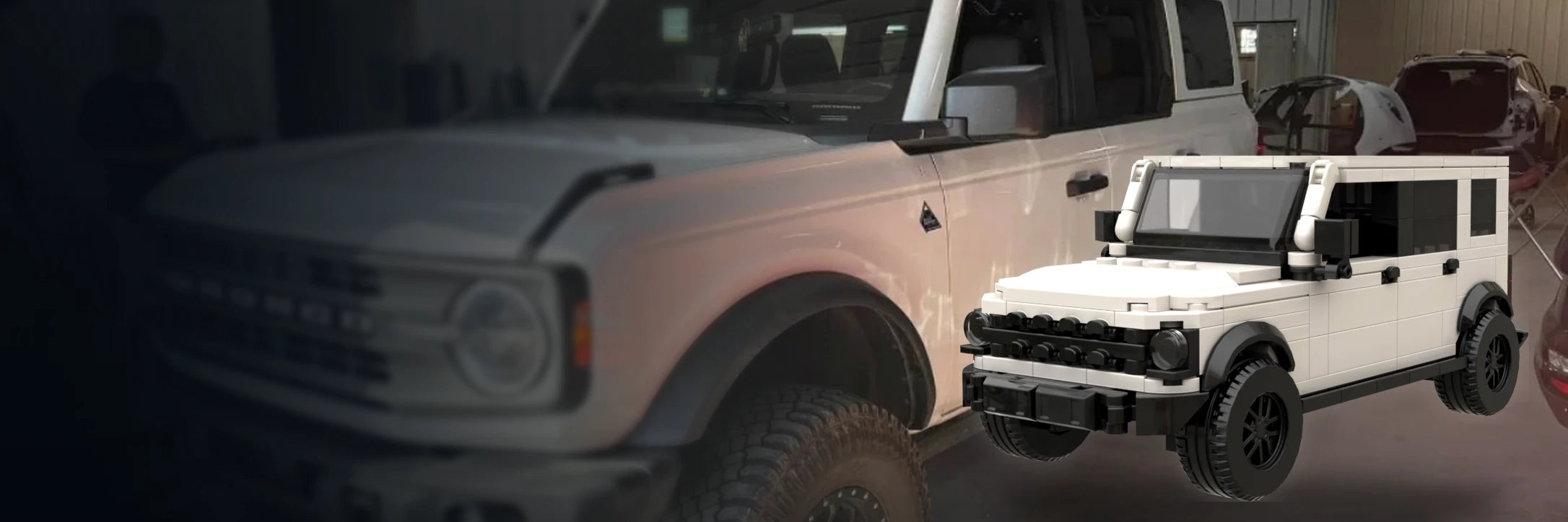 Real white off-road SUV beside its matching custom brick model